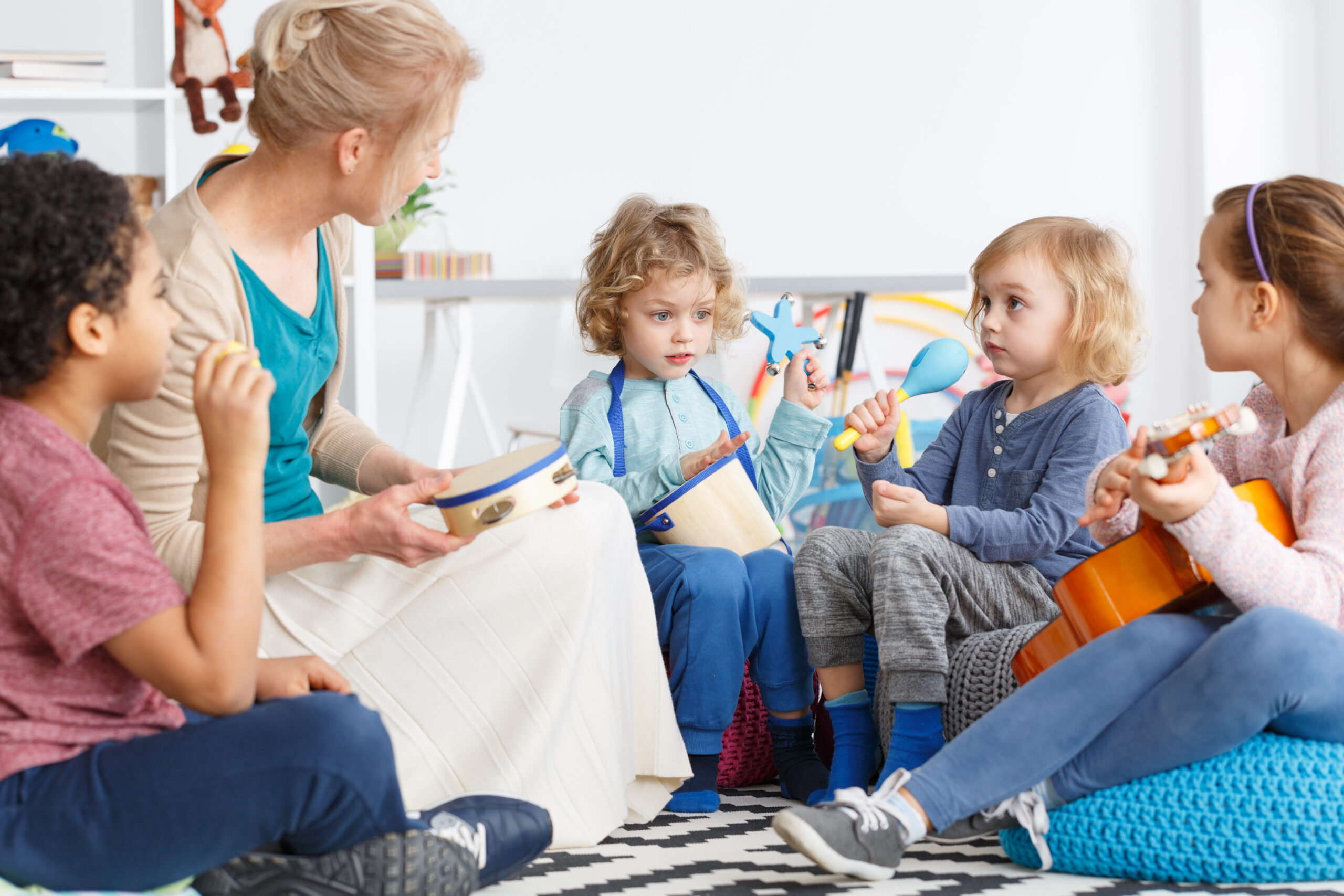 Kids with instruments Little kids in kindergarten playing instruments during music lesson